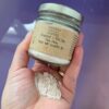 Glass jar of kaolin clay face mask with powder inside, surrounded by natural elements like a wooden spoon, dried flowers, and soft lighting—evoking a calm, luxurious skincare ritual